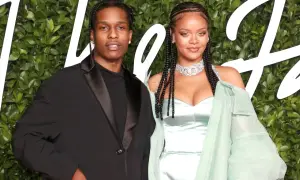 Rihanna i jej mąż A$AP Rocky pozują na tle zieleni.
