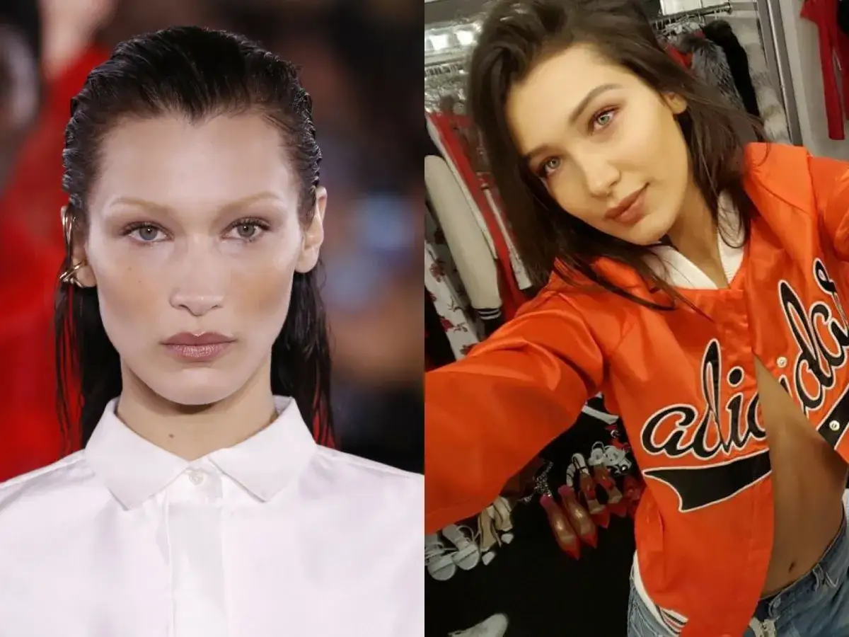 Bella Hadid w pomarańczowej kurtce i białej koszuli. Jej wiek nie jest widoczny na zdjęciu, ale stylizacja jest modna.