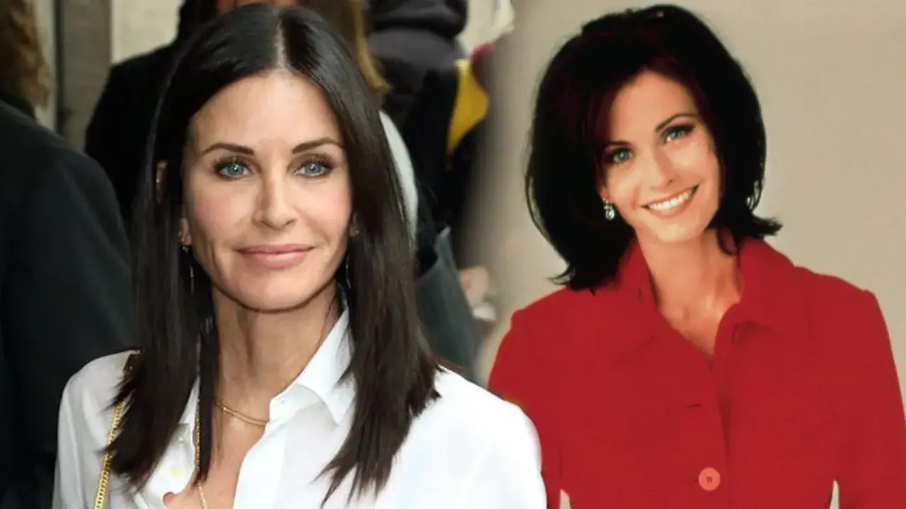 Courteney Cox, która gwiazda ma obsesję na punkcie czystości i sama sprząta swój dom, w białej koszuli i czerwonej marynarce.